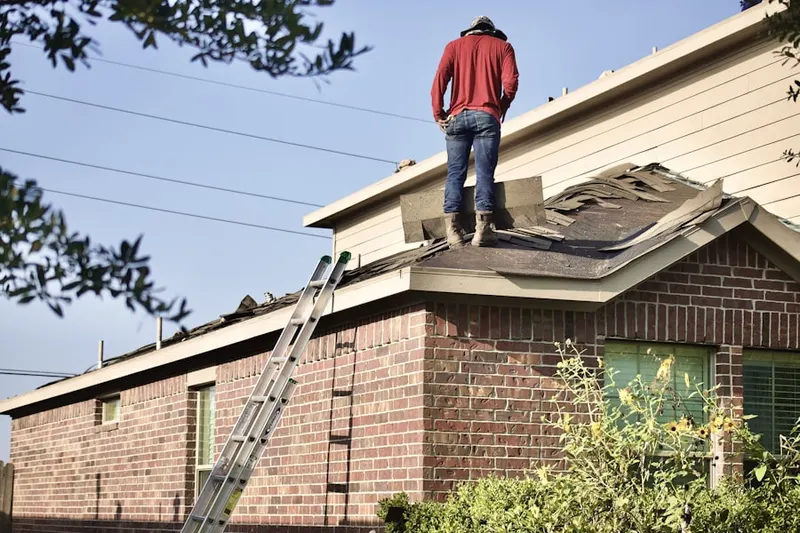 Professional roofer working on a residential roof in Easton
